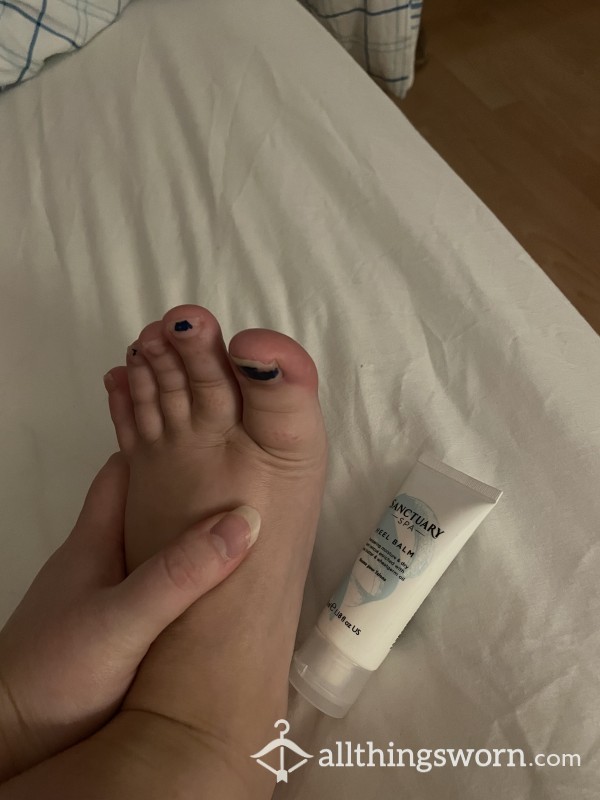 Rubbing Foot And Heel Cream Into Tired And Smelly Feet