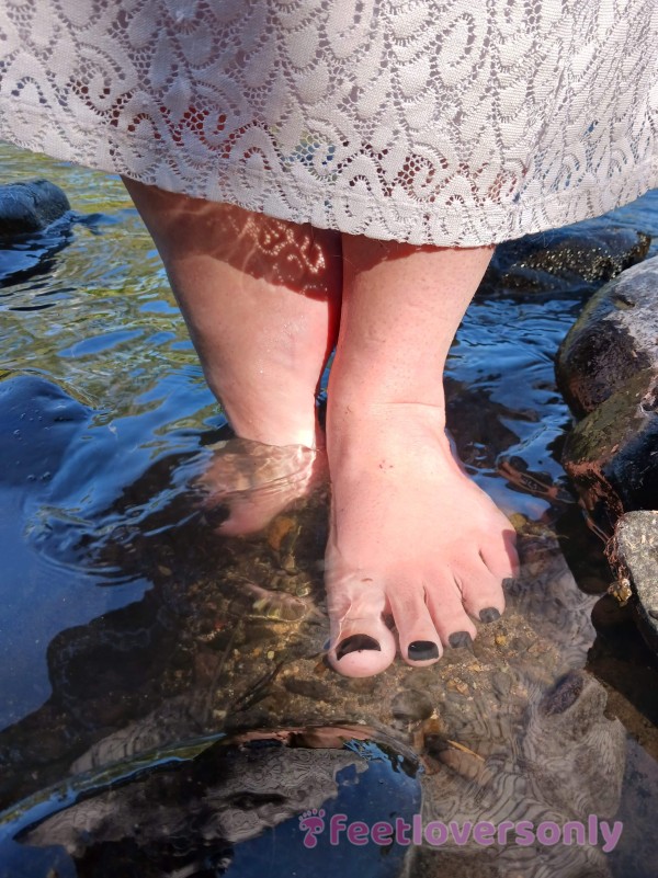 Standing In The River With My White Lace Dress Peeking Over Ankles