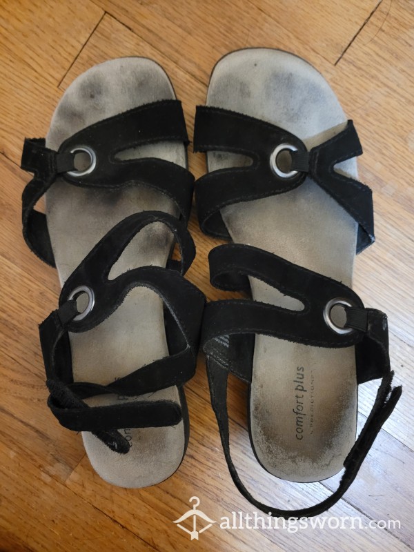 Well-Worn Sandals With Feet Prints