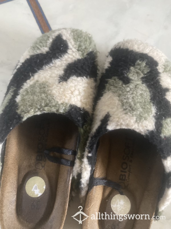 Well Worn Slippers With Feet Marks