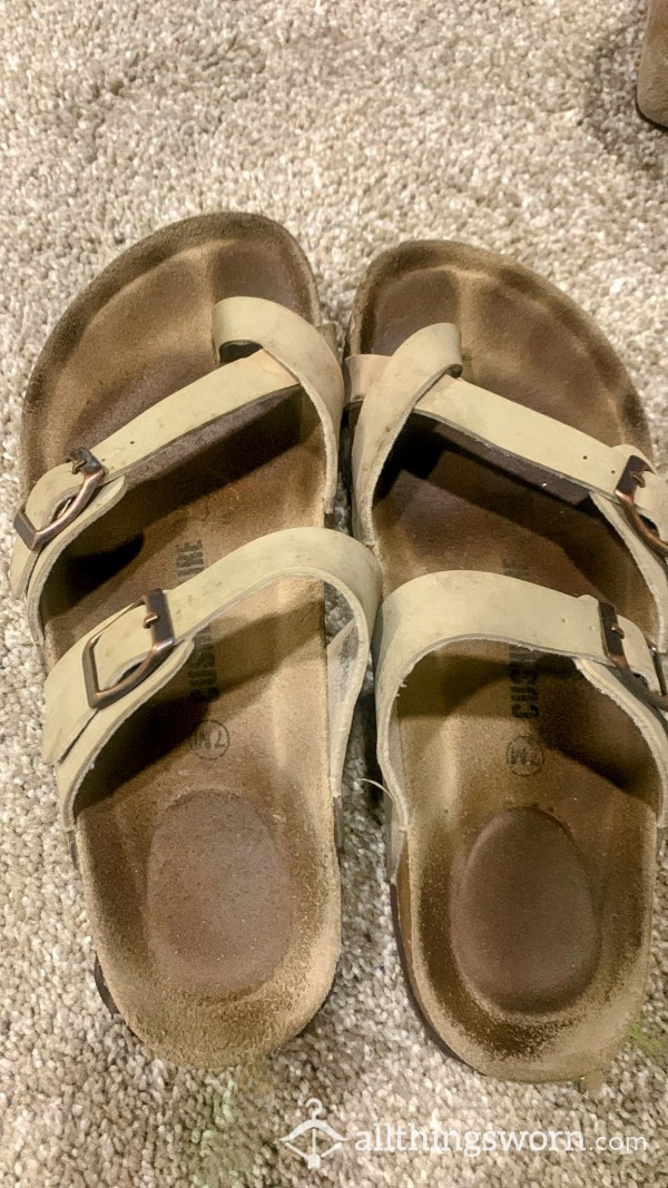 Worn Out Sandals With Toe Prints